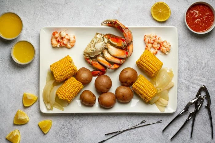 large plate in the middle of table how long to boil shrimp corn on the cob onions lemon wedges on the side