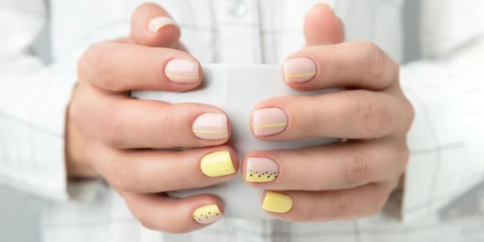 matte nude nail polish with yellow and black dots and lines summer nail designs short nails