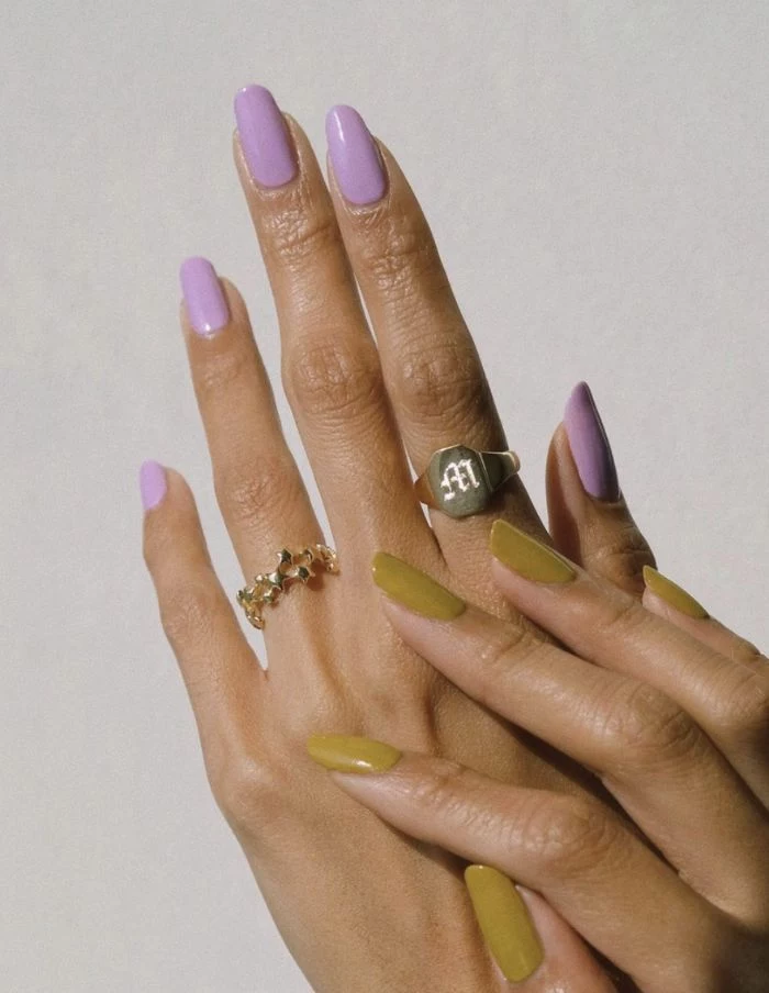 medium length nails with purple nail polish on one hand nail designs 2021 green nail polish on other hand