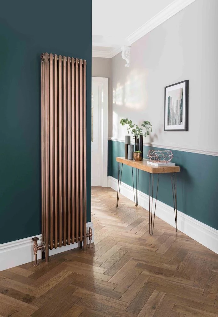 narrow hallway ideas brass metal heat fixtures dark green walls wooden floor and shelf with vases