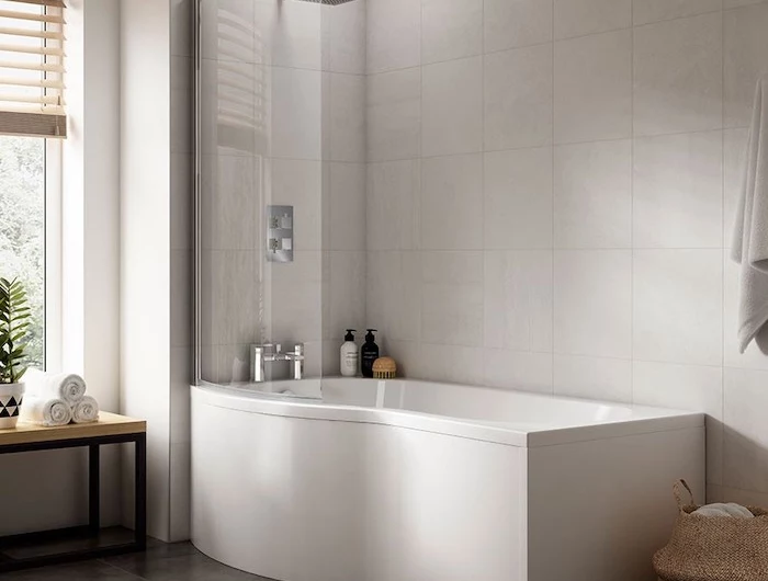 p shaped bath in bathroom with white tiles on the walls dark tiles on the floor shower bath ideas