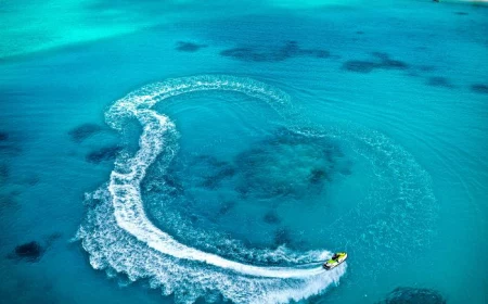person riding jet ski in turquoise cleat water iphone beach wallpaper leaving trail behind