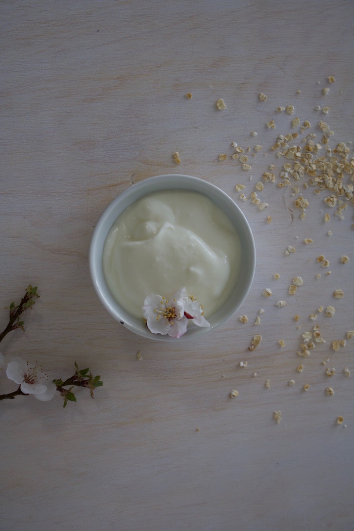 plain yogurt in white ceramic bowl best hair mask for dry hair small flower on the side