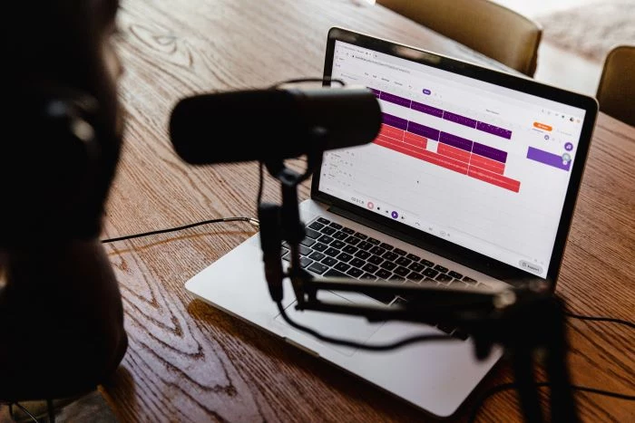 podcast setup on wooden table lifestyle podcast examples laptop and microphone on the table