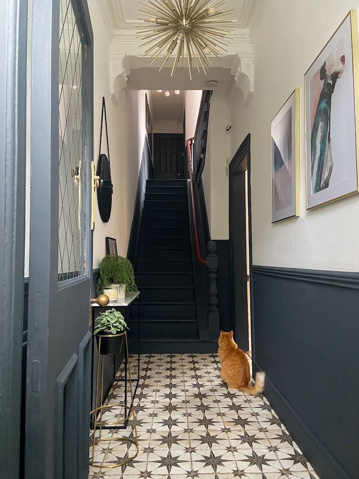 tiled floor in black and white dark blue staircase decorating ideas for entry hall framed art on the wall