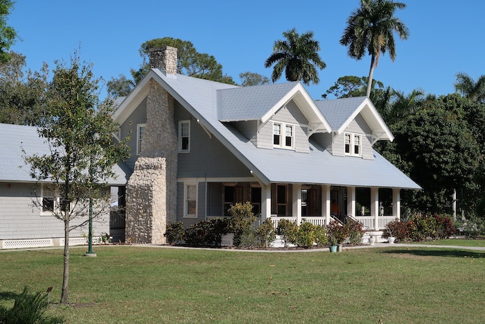 two storey house with a large front porch buying a new home tall palm trees in the backyard