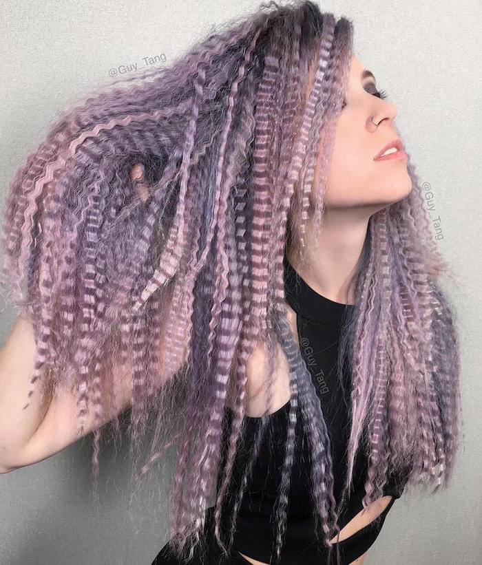 woman with long hair dyed in pink and purple crimped hairstyles wearing black top