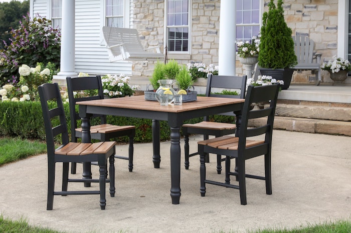 wooden table and chairs lemonade pitcher and glasses in the middle farmhouse garden table