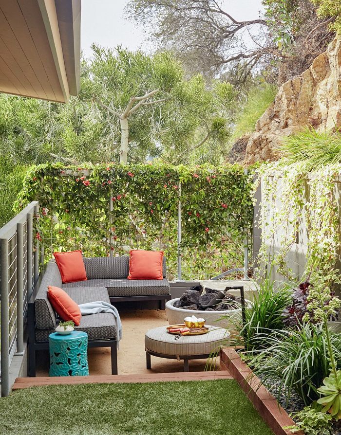 The Most Unique Backyard Design Ideas For A Beautiful Garden Space   Backyard Decor Ideas Small Wooden Corner Sofa With Orange Throw Pillows Ottoman Next To Fire Pit 