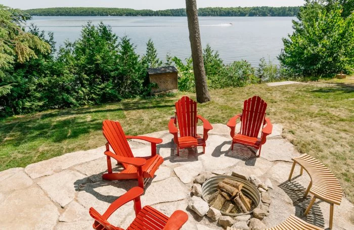 backyard patio ideas on a budget four red wooden lounge chairs wooden benches arranged around fire pit