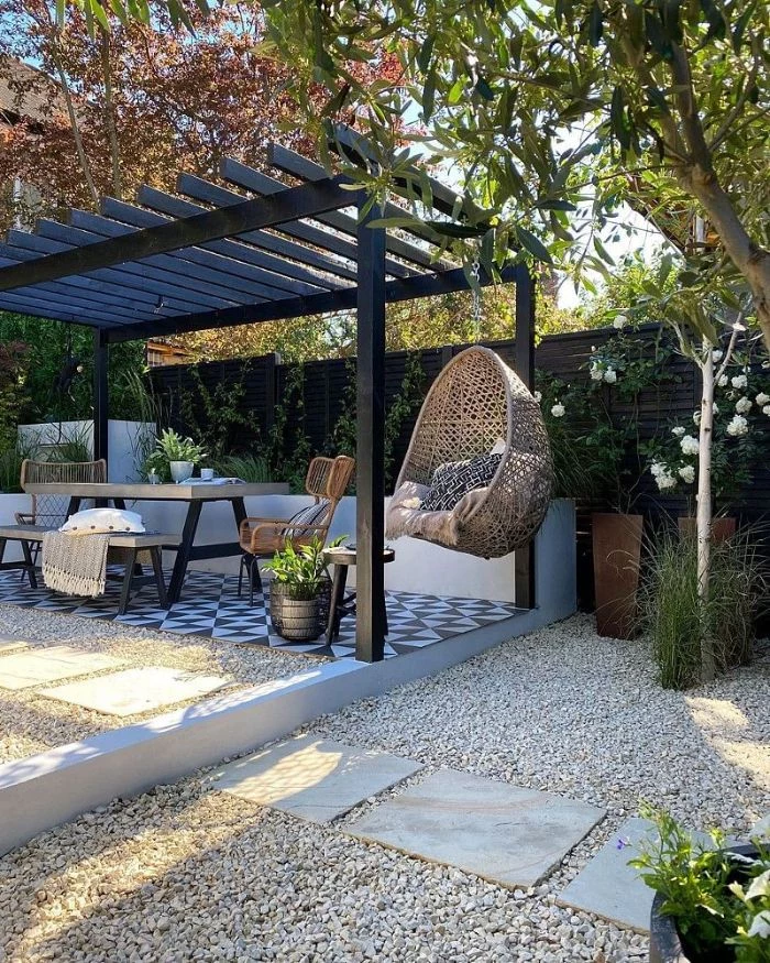 black wooden pergola wooden table chairs bench and swing underneath backyard patio ideas on a budget black and white tiles