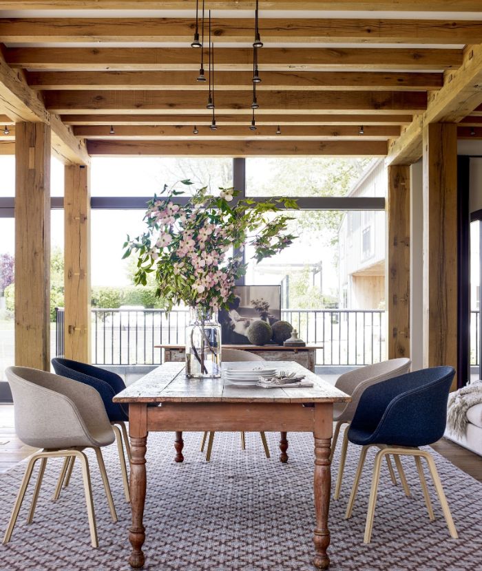 blue and gray chairs around table placed on colorful carpet farmhouse dining room decor exposed wood beams