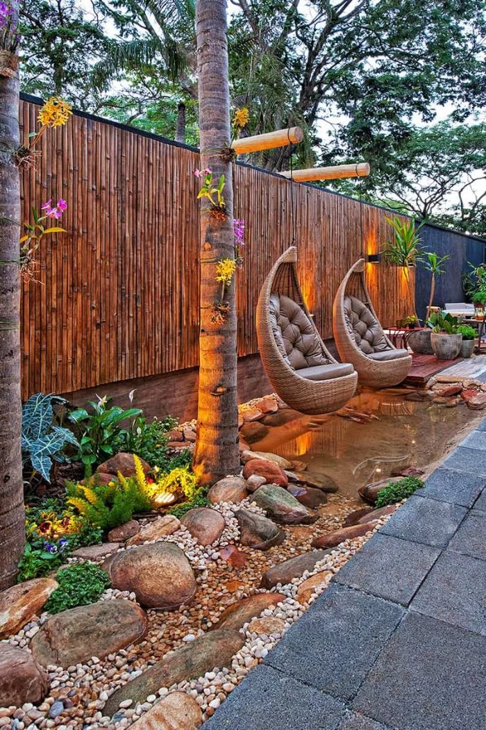 brown leather cushions on two swings over small pond landscape design ideas surrounded by rocks and plants