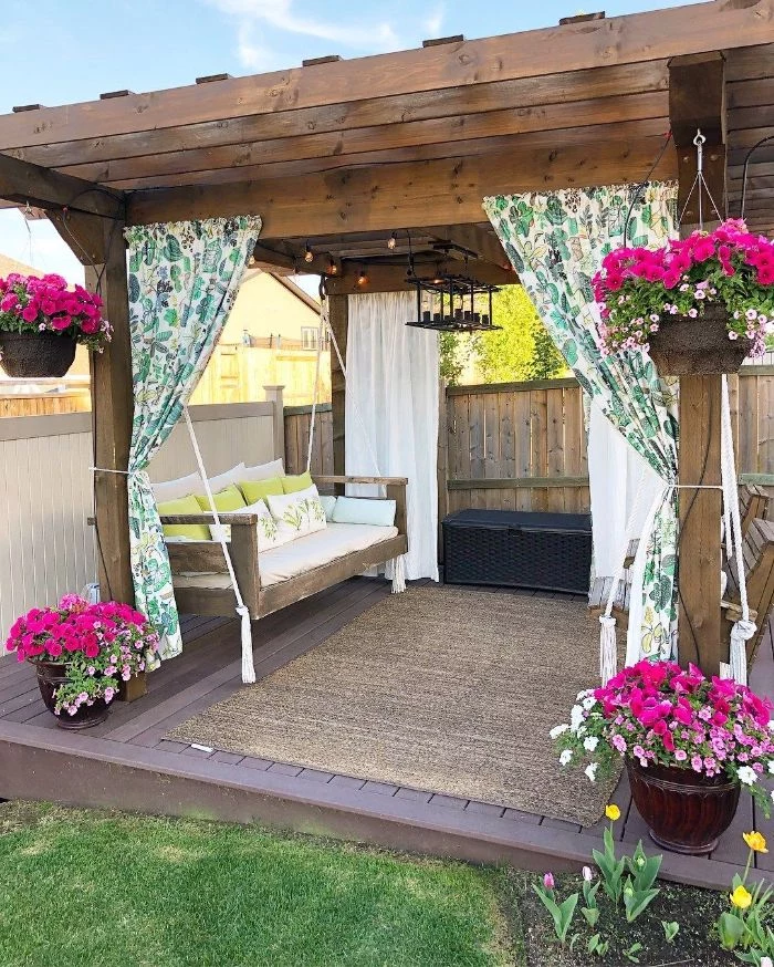 colorful curtains hanging from wooden pergola backyard design ideas wooden swing underneath