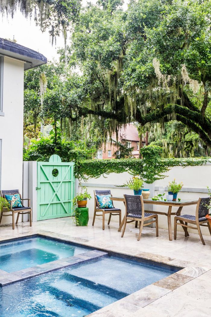 dining area next to the pool table and wooden chairs backyard patio ideas under large tree