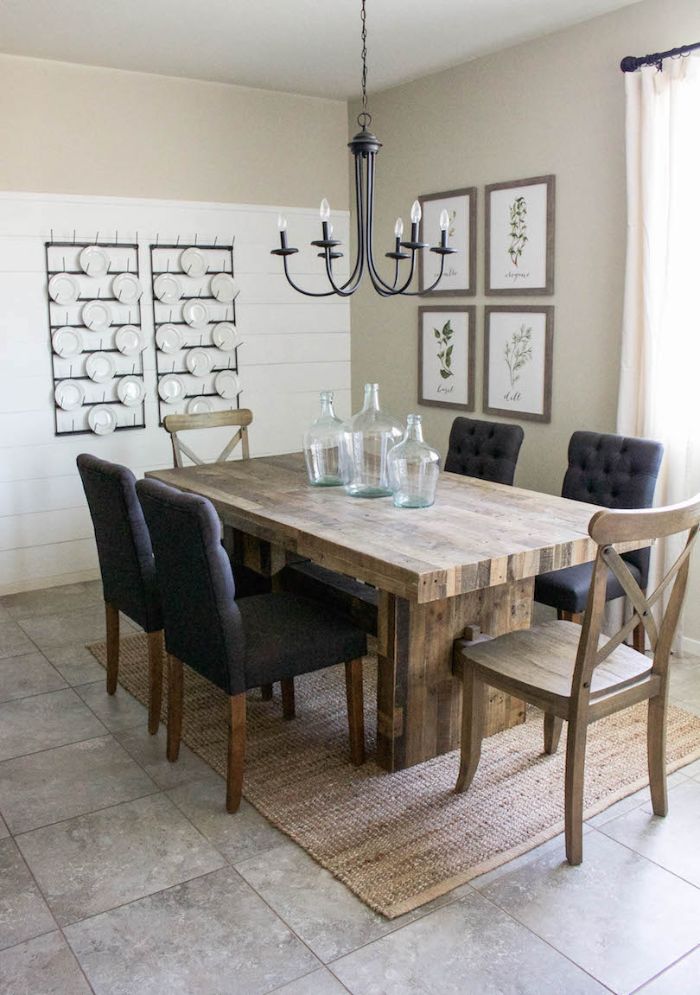 dining room table decor three empty vases on table black chairs around it plates hanging on the wall