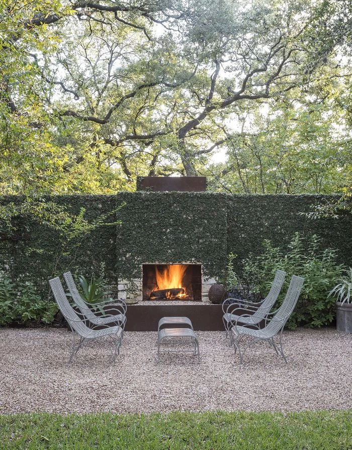 diy backyard ideas fireplace outside on wall covered with ivy four lounge chairs in front of it