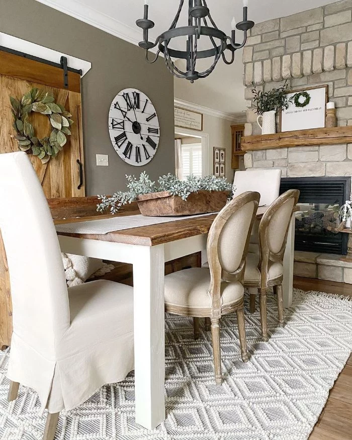 farmhouse dining room white chairs and wooden table in front of fireplace sliding barn doors