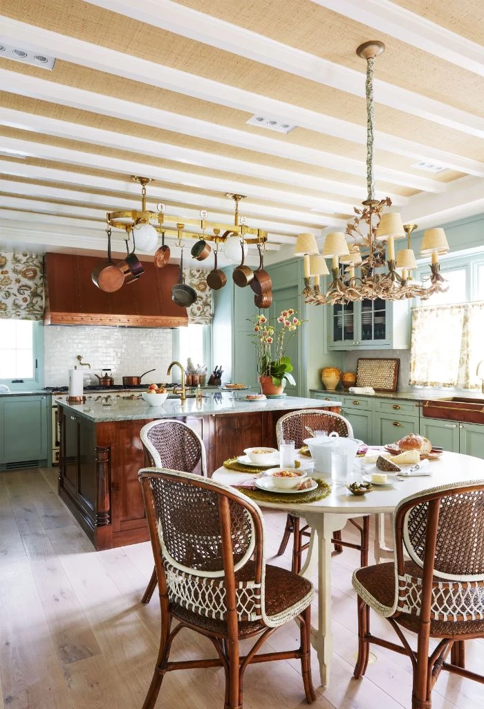 farmhouse kitchen table vintage chairs kitchen island pans hanging from the ceiling above