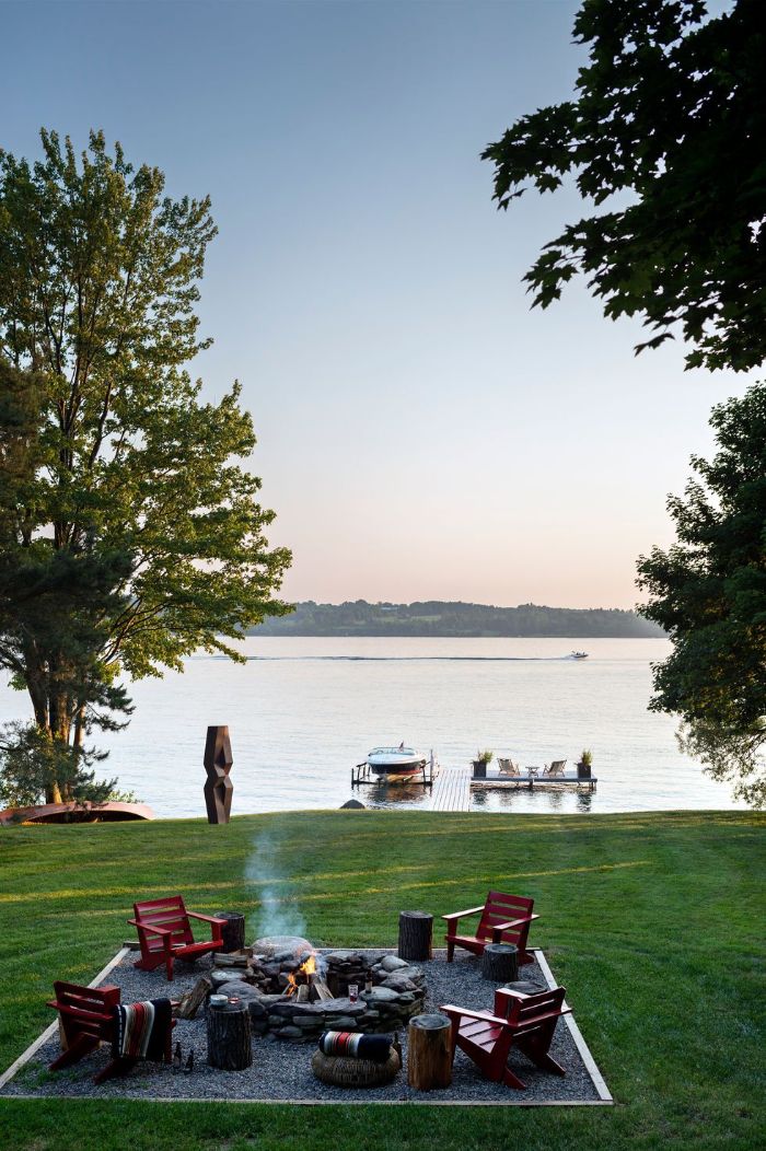 fire pit surrounded by four red wooden lounge chairs diy backyard ideas lake house