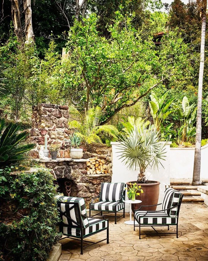 landscape design ideas three black and white chairs in front of stone fireplace surrounded by trees