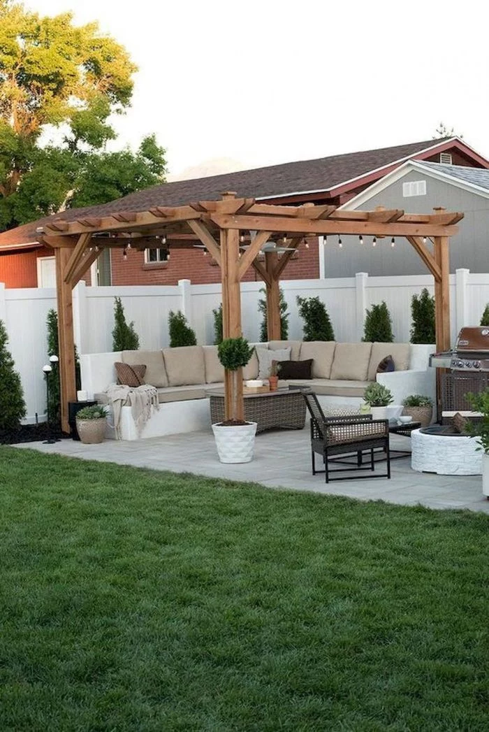 pergola with large sofa underneath rattan garden furniture small backyard landscaping ideas barbeccue on the side