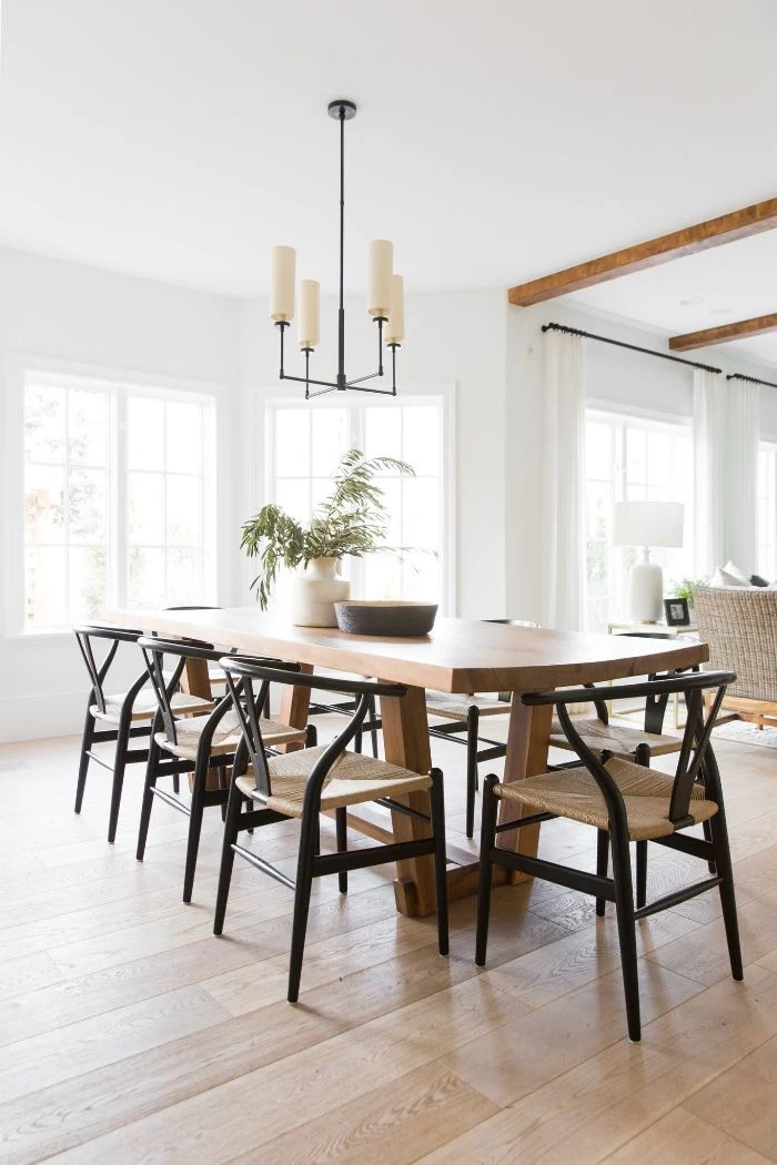 rustic dining table made of wood black chairs around it minimalistic design