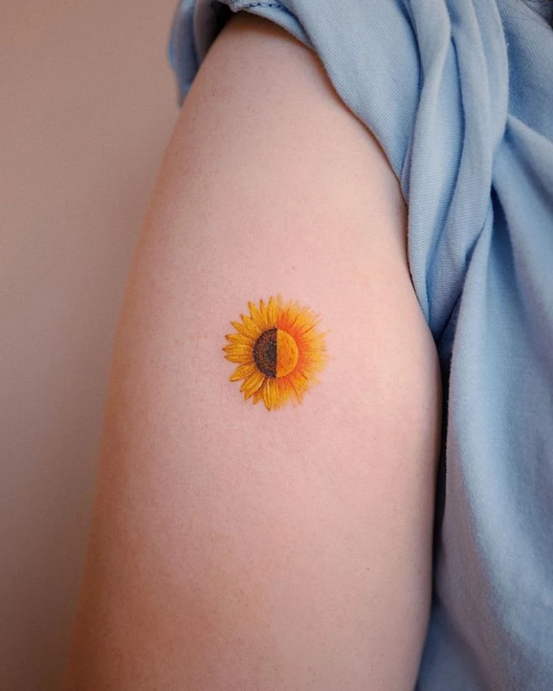 small sunflower tattoo on the side of shoulder