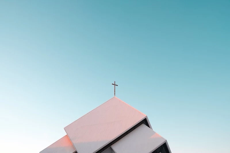 blue sky with church building with cross