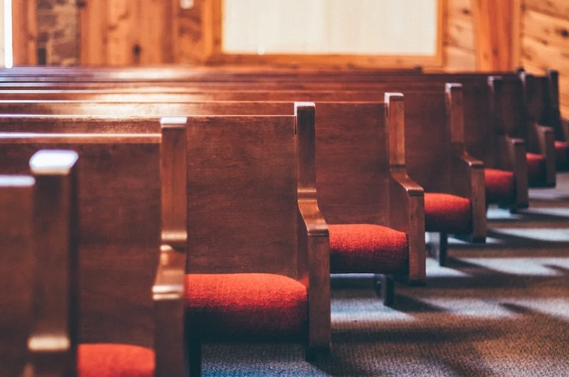 church pews in red and wood church chairs