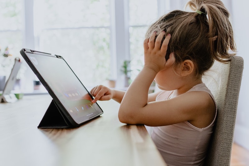 girl playing with tablet blond little girl