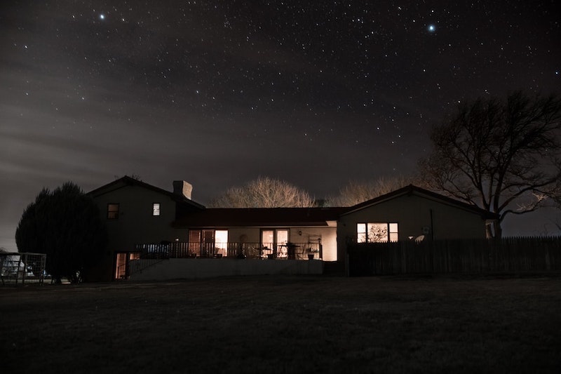 house during the night sky full of stars