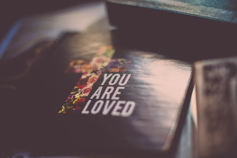 photo of bible with you are loved quote