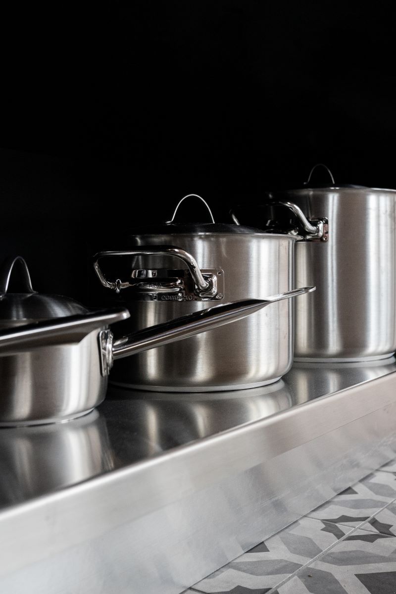 three steel pots steel kitchen colorful tiles