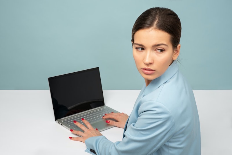 woman typing on computer keybord blue blazer