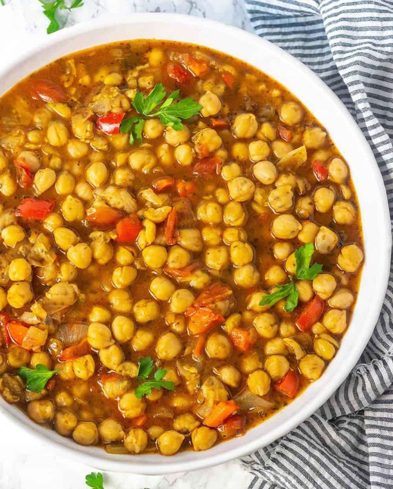 chickpea soup with vegetables in white bowl