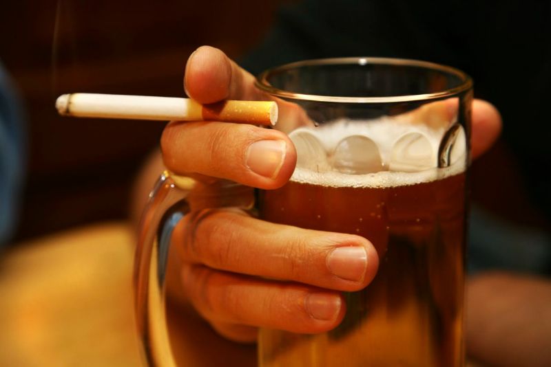 man holding beer liver healing foods cigarette