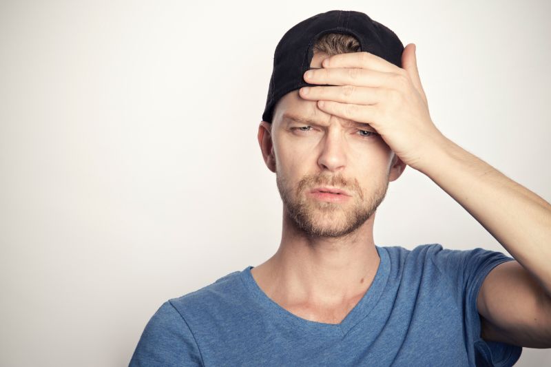 man holding his head liver healing foods headache