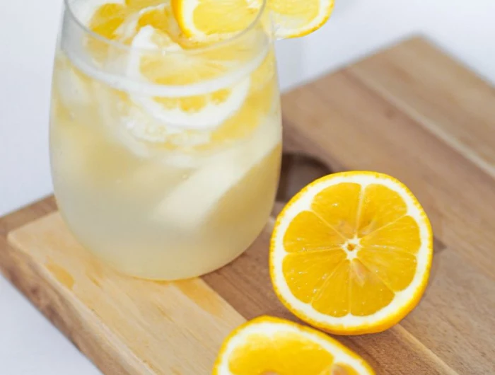 water in glass is lemon water good for you with lemon slices