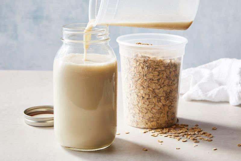 milk poured into jar make oat milk oats in jar