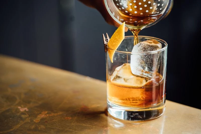small glass whiskey cocktails orange twist