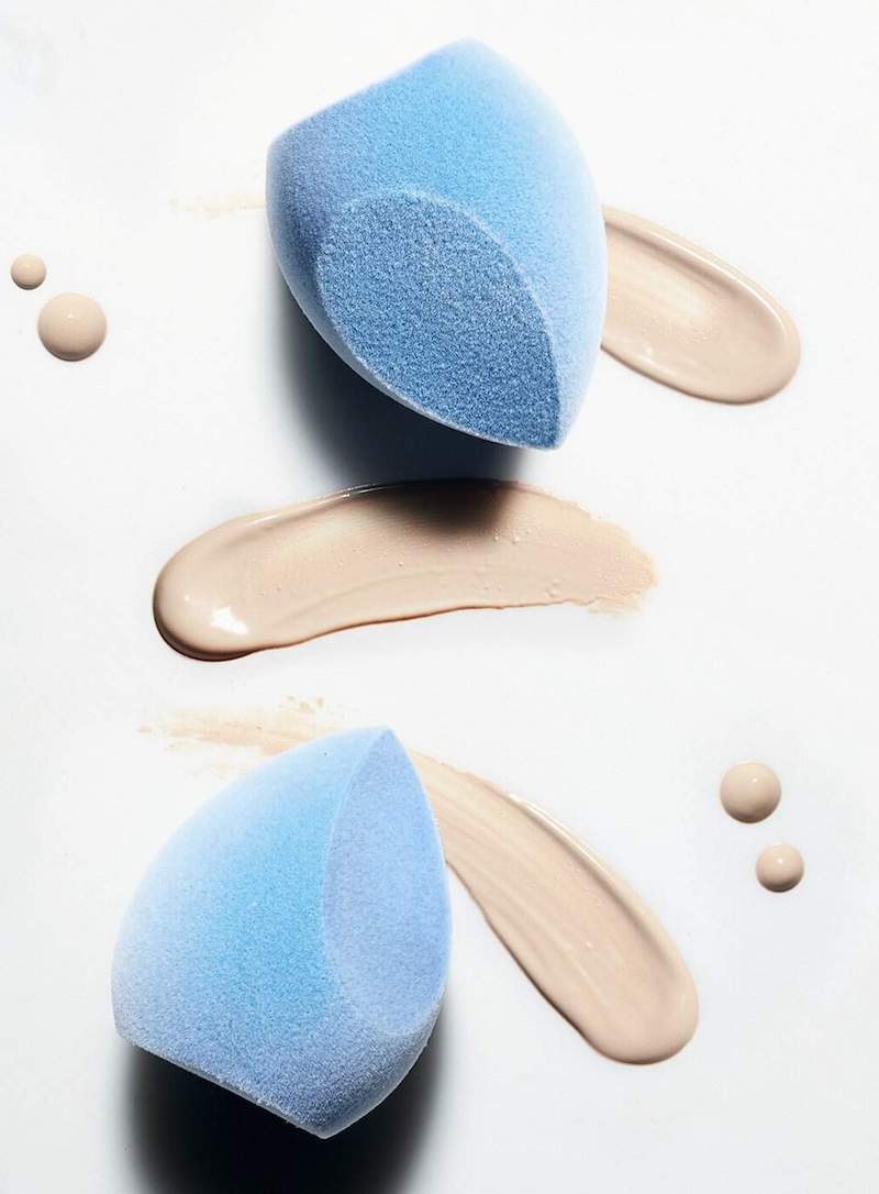 blue microfiber makeup sponges with foundation splashes