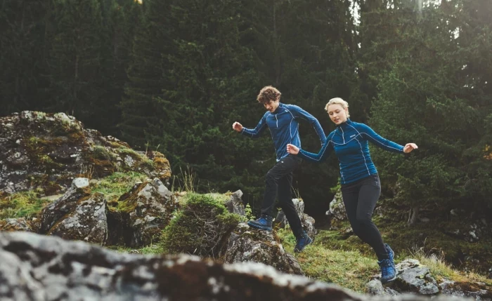 couple hiking in the mountains in thermal underwear
