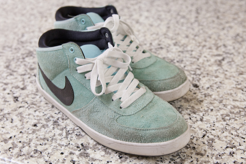 dirty suede nike sneakers with darker spots and discoloration