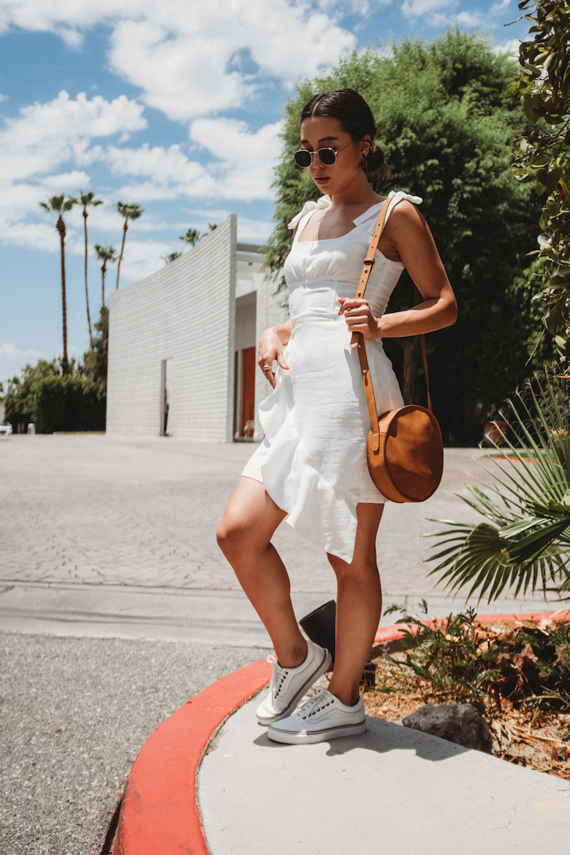 girl styling white vans shoes with white dress