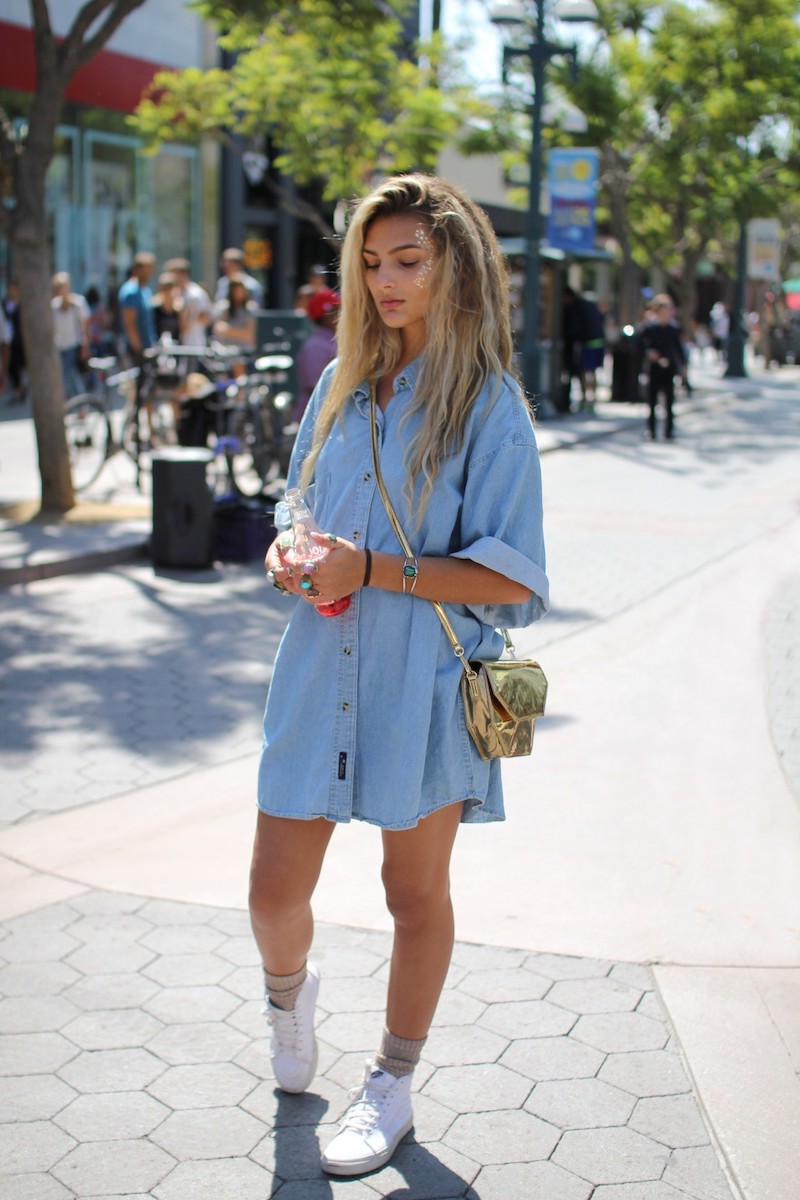 girl wearing all white vans shoes holding