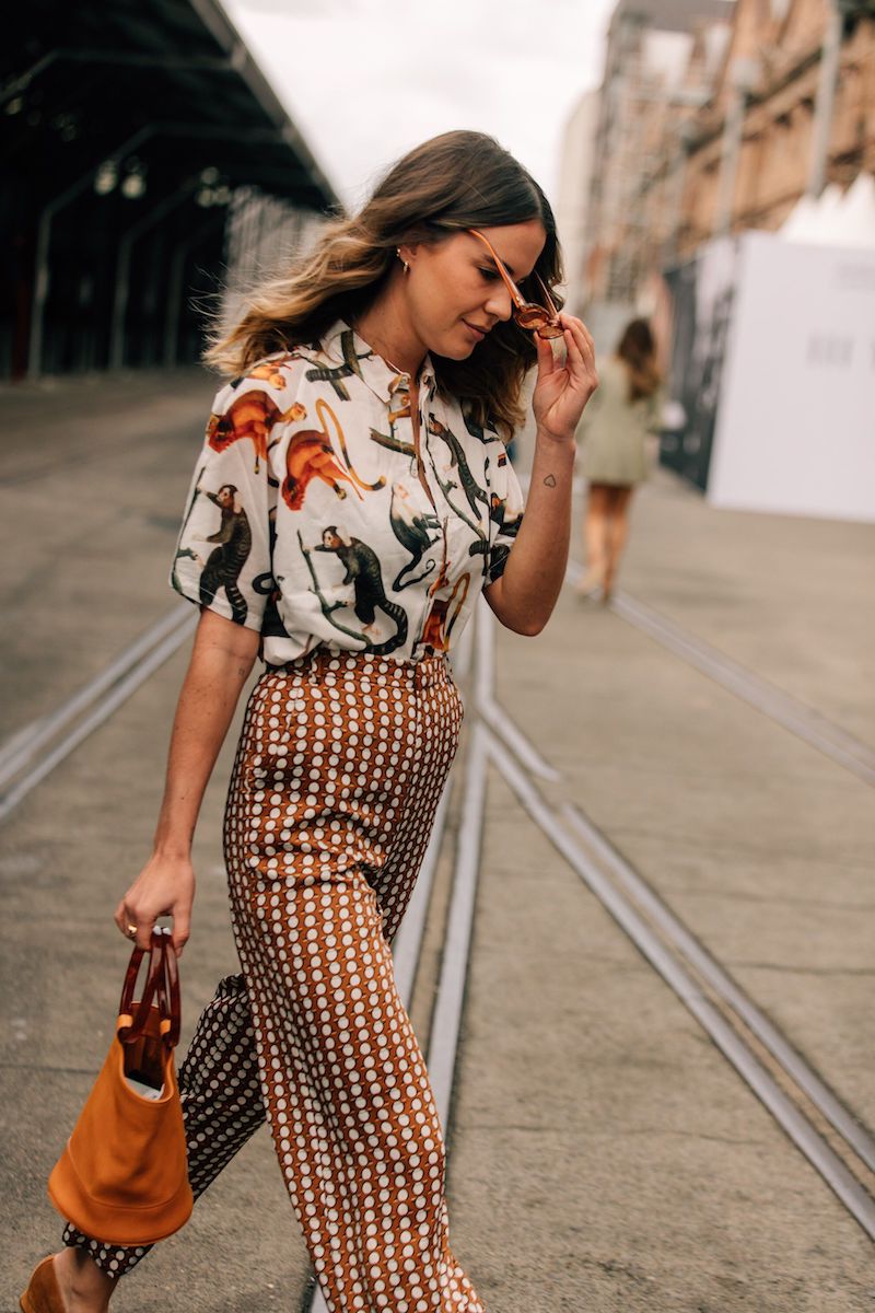 girl wearing animal print blouse and orange bag