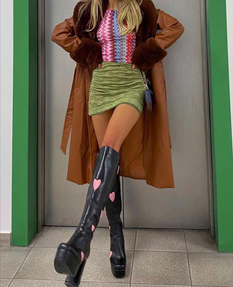 girl wearing trendy chunky high boots and a long coat