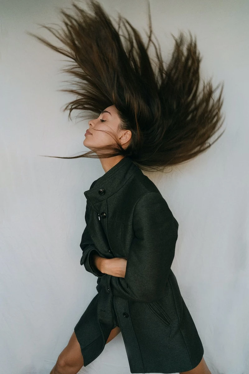 girl with long beautiful healthy hair and a black jacket