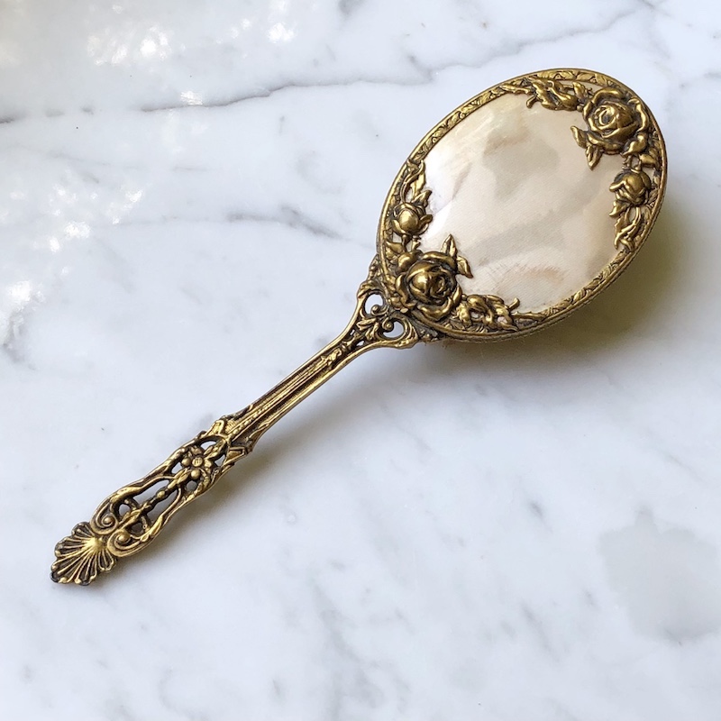 gorgeous gold vintage hair brush on marble background